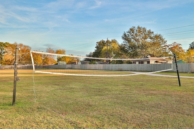 surrounding community featuring volleyball court and a lawn