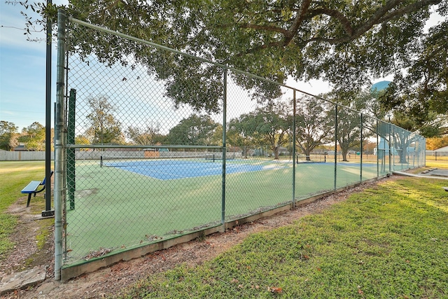 view of sport court featuring a yard