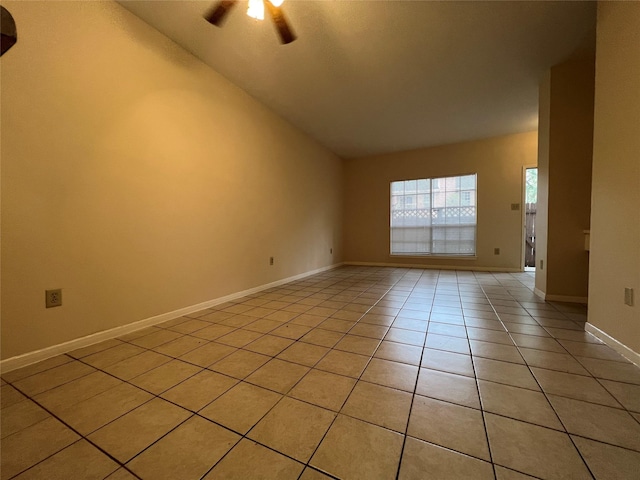 tiled spare room featuring ceiling fan and vaulted ceiling