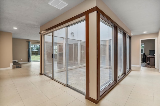 entryway with light tile patterned floors