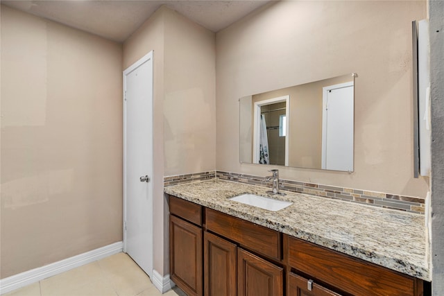 bathroom featuring backsplash, tile patterned flooring, and vanity