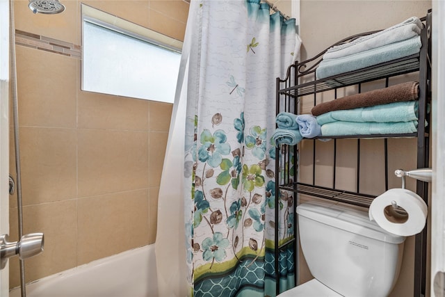 bathroom featuring shower / tub combo with curtain and toilet