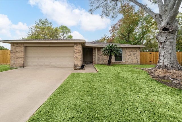 single story home featuring a front yard and a garage