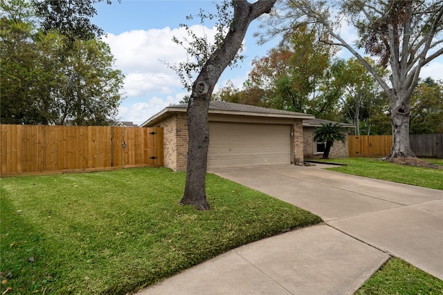 ranch-style house featuring a front yard and a garage