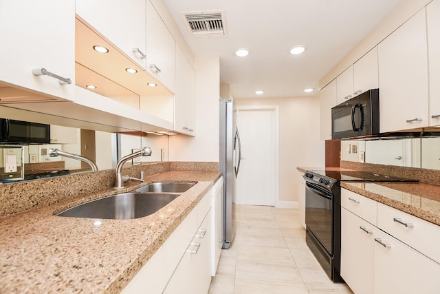 kitchen with light stone countertops, sink, white cabinets, and black appliances