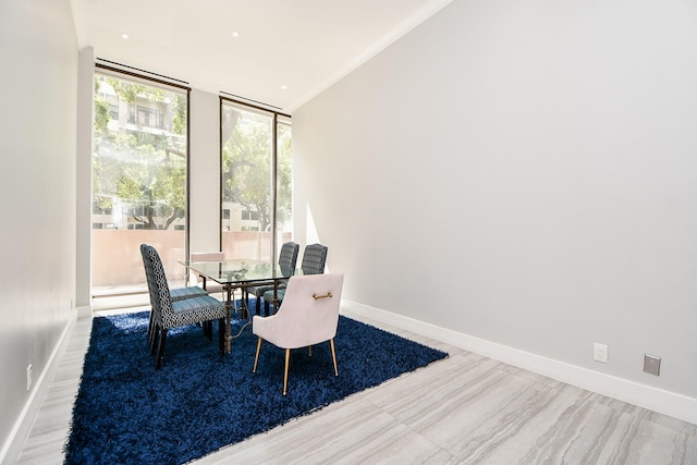 dining room with floor to ceiling windows and crown molding