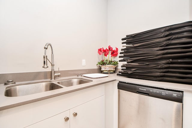 kitchen with white cabinetry, stainless steel dishwasher, and sink