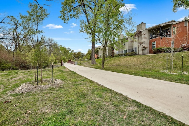 view of home's community with a yard