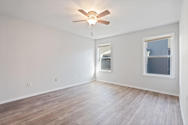 spare room with ceiling fan and light wood-type flooring