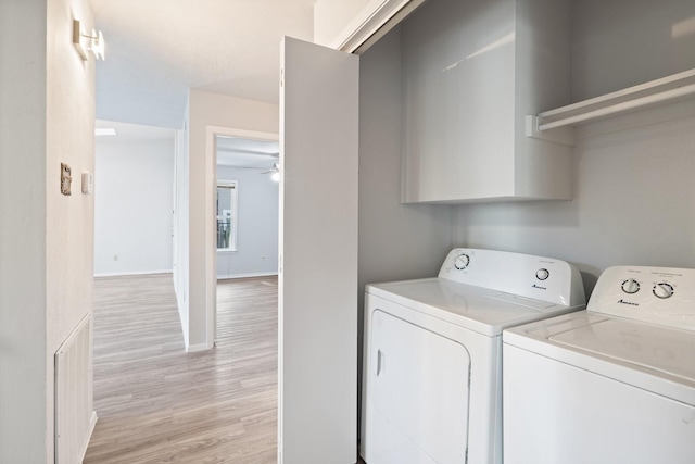 clothes washing area with light hardwood / wood-style flooring, washer and clothes dryer, and ceiling fan