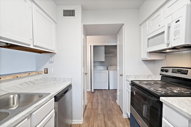 kitchen with white cabinetry, washer and clothes dryer, stainless steel appliances, and light hardwood / wood-style flooring