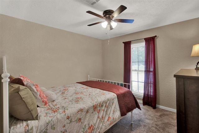 carpeted bedroom with a textured ceiling and ceiling fan