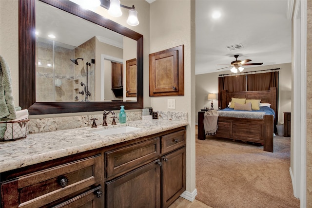 bathroom featuring crown molding, ceiling fan, vanity, and walk in shower