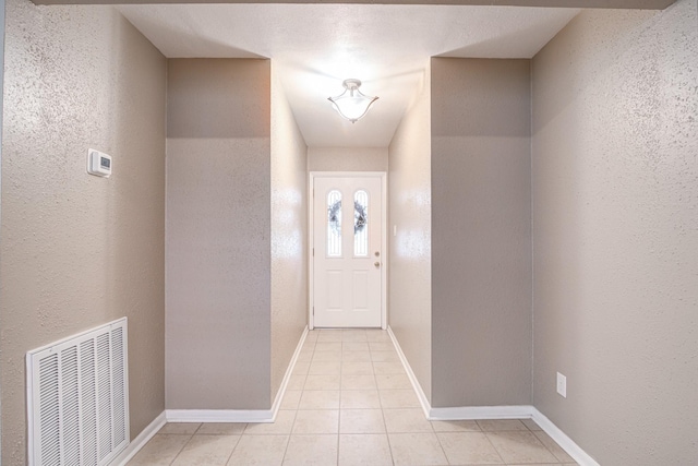 entryway with light tile patterned flooring