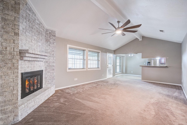 unfurnished living room with carpet flooring, vaulted ceiling with beams, ceiling fan, and a fireplace