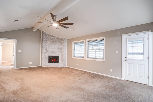 unfurnished living room with vaulted ceiling with beams, ceiling fan, light carpet, and a brick fireplace