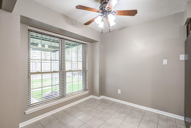 unfurnished room featuring ceiling fan and light tile patterned floors