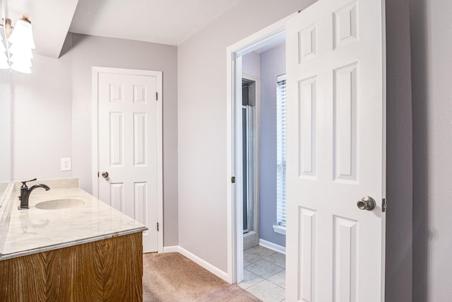 bathroom with tile patterned floors, vanity, and an enclosed shower