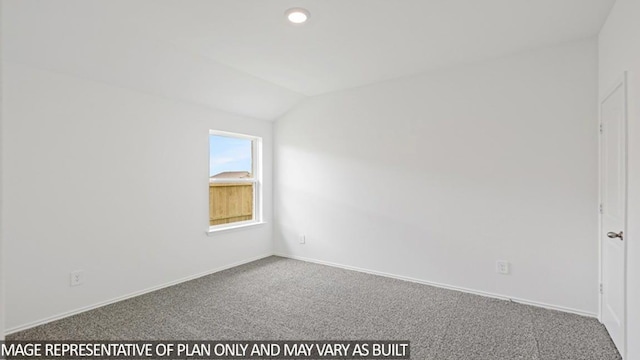 spare room featuring carpet flooring and lofted ceiling