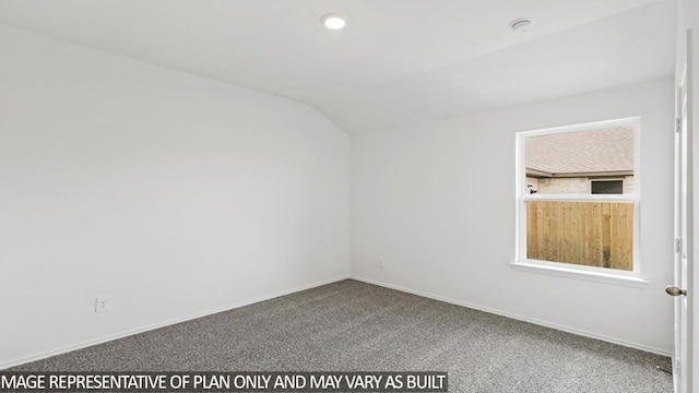 carpeted empty room with vaulted ceiling