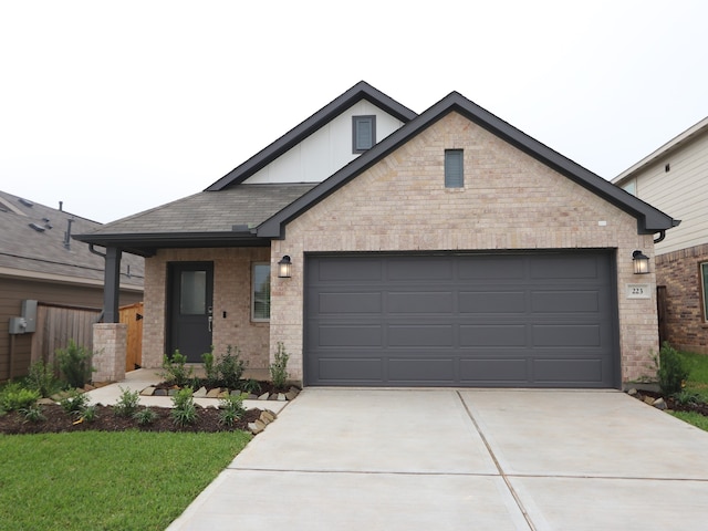 223 River Grove St, Willis, TX 77378 - view of front of home featuring brick siding, a garage, board and batten siding, and concrete driveway