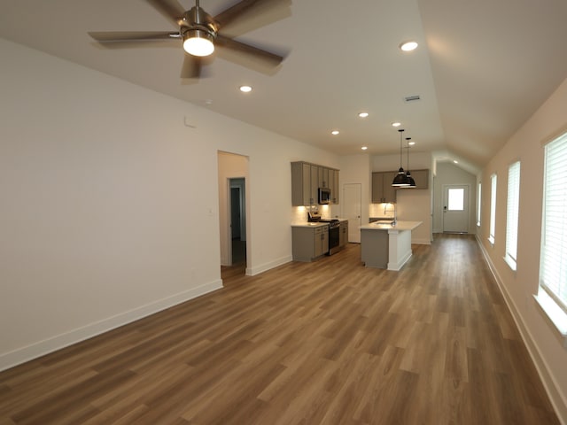 223 River Grove St, Willis, TX 77378 - unfurnished living room featuring recessed lighting, baseboards, vaulted ceiling, and dark wood finished floors