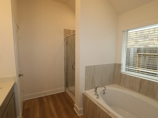 223 River Grove St, Willis, TX 77378 - full bathroom featuring vanity, a shower stall, a garden tub, and wood finished floors