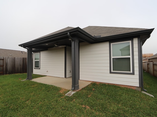 223 River Grove St, Willis, TX 77378 - rear view of property with roof with shingles, ceiling fan, a fenced backyard, a patio, and a yard
