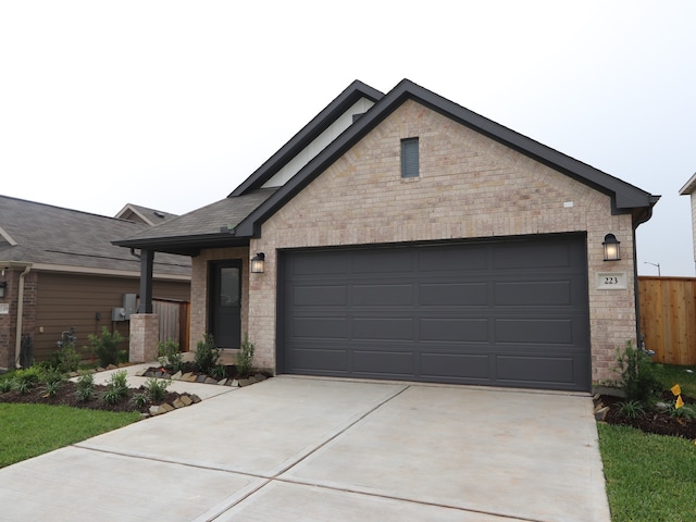223 River Grove St, Willis, TX 77378 - view of front facade featuring a garage, fence, driveway, and brick siding