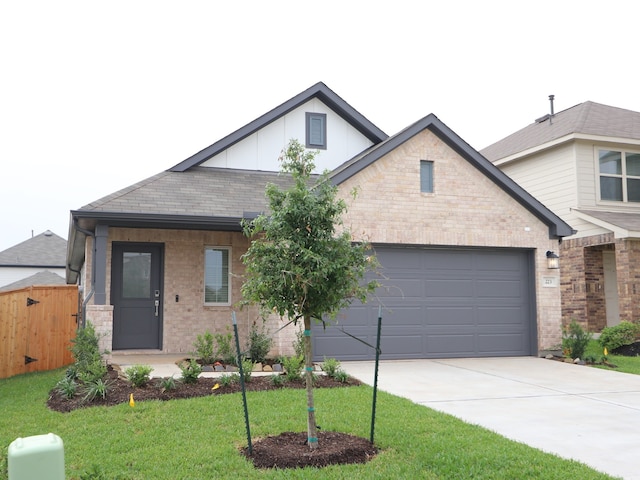 223 River Grove St, Willis, TX 77378 - view of front facade featuring a garage, a front lawn, fence, board and batten siding, and concrete driveway