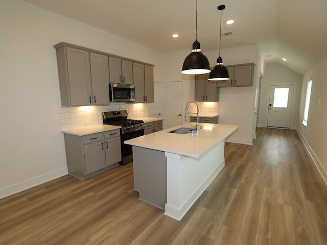 223 River Grove St, Willis, TX 77378 - kitchen with gray cabinetry, appliances with stainless steel finishes, a sink, and tasteful backsplash