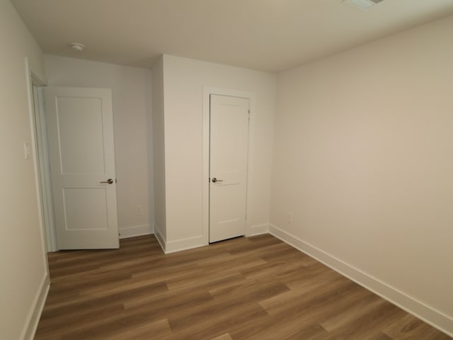 223 River Grove St, Willis, TX 77378 - unfurnished bedroom with baseboards and wood finished floors