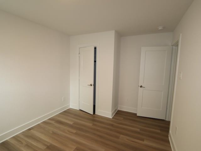 223 River Grove St, Willis, TX 77378 - unfurnished bedroom with baseboards and wood finished floors