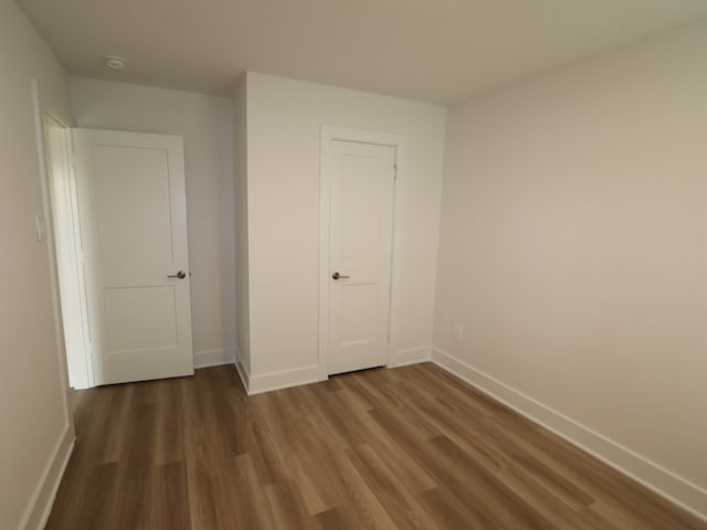 223 River Grove St, Willis, TX 77378 - unfurnished bedroom with baseboards and wood finished floors