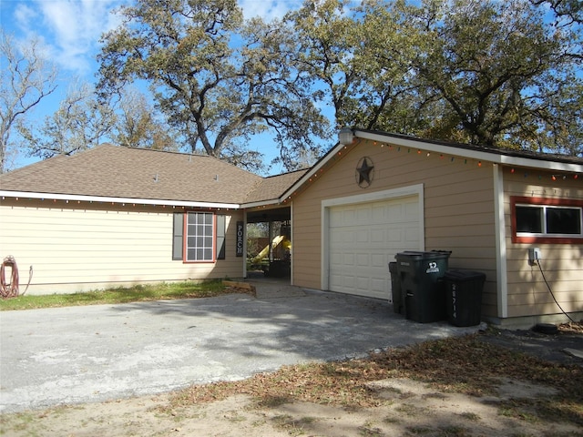 rear view of house featuring a garage