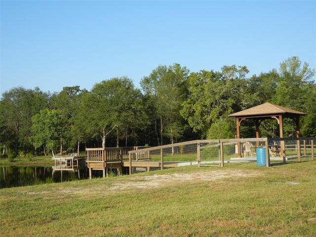 exterior space with a gazebo, a yard, and a water view