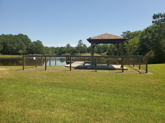 surrounding community featuring a gazebo, a water view, and a yard