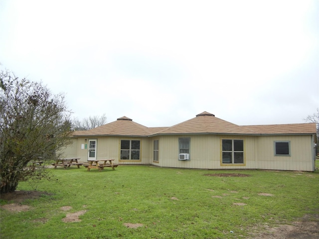 back of house featuring cooling unit and a yard