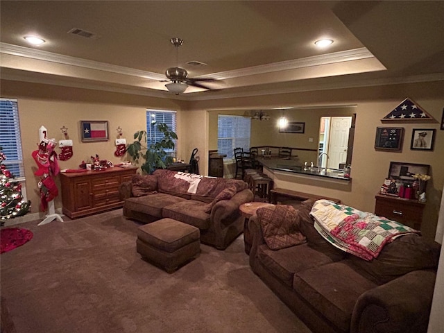 living room with carpet floors, ceiling fan, and crown molding