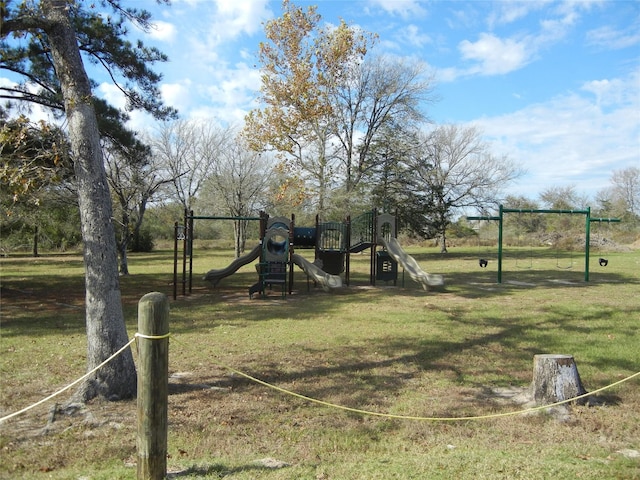 view of jungle gym featuring a lawn