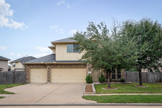 view of front facade with a garage and a front lawn