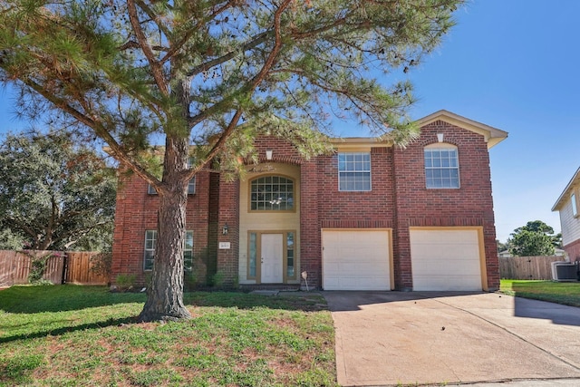 view of front of home with cooling unit, a front yard, and a garage