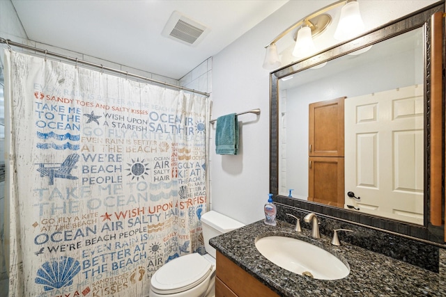 bathroom featuring a shower with shower curtain, vanity, and toilet