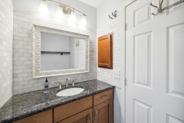 bathroom with vanity and tasteful backsplash