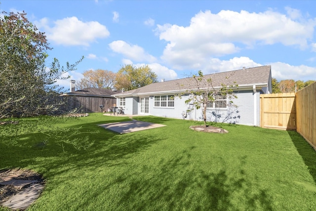 back of house with a patio and a lawn