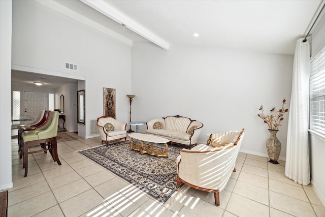 living room with vaulted ceiling with beams and light tile patterned floors