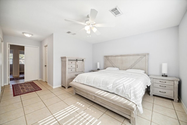 bedroom featuring light tile patterned floors and ceiling fan