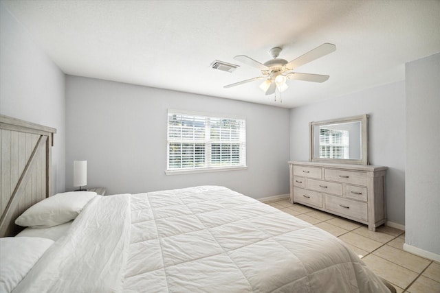 tiled bedroom featuring ceiling fan