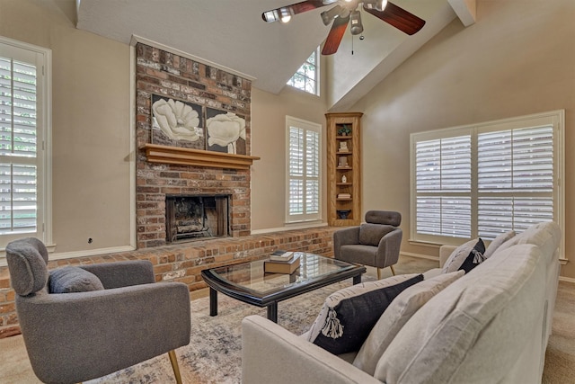 living room with beamed ceiling, ceiling fan, light colored carpet, and a brick fireplace