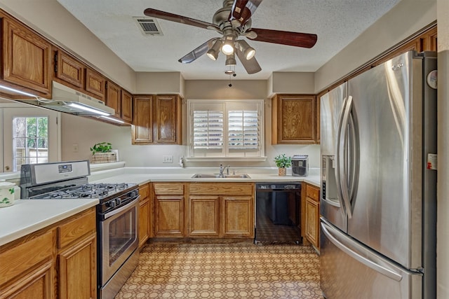 kitchen featuring ceiling fan, sink, stainless steel appliances, a textured ceiling, and exhaust hood